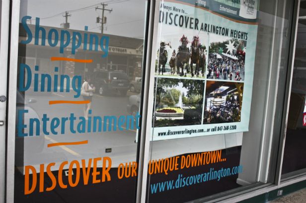 Discover Arlington.  Combine window lettering with banners for a multi-layered low cost storefront display.